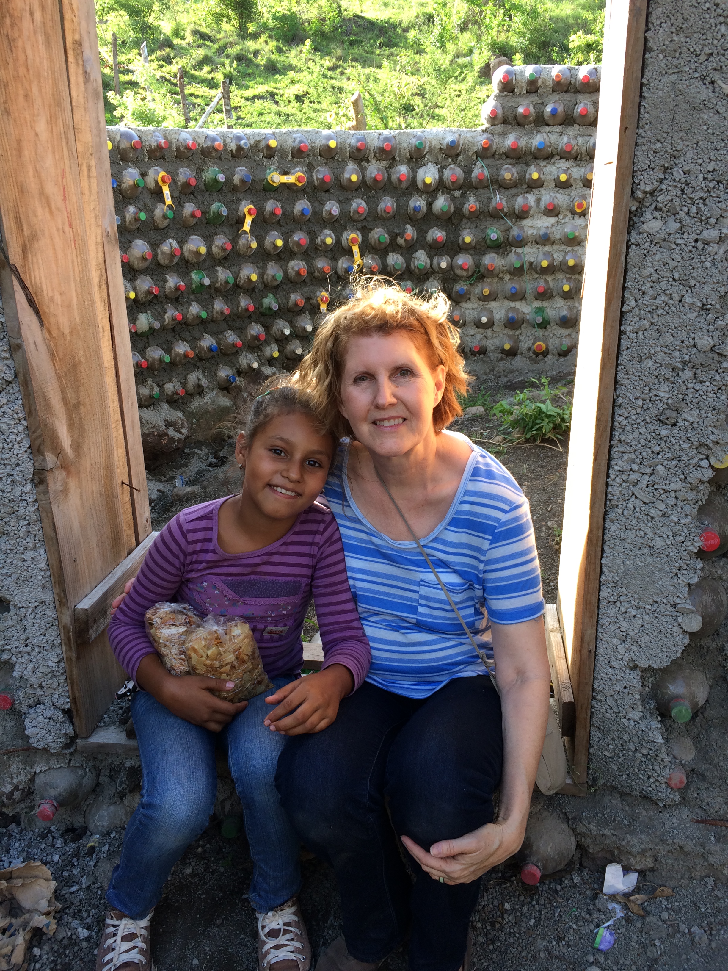By the house made of pop bottles.
